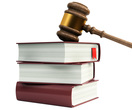 photo of a gavel leaning on three stacked books