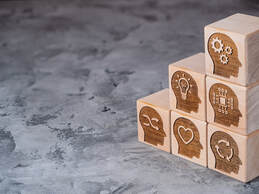 Blocks with various icons conveying learning arranged in a stairstep pattern